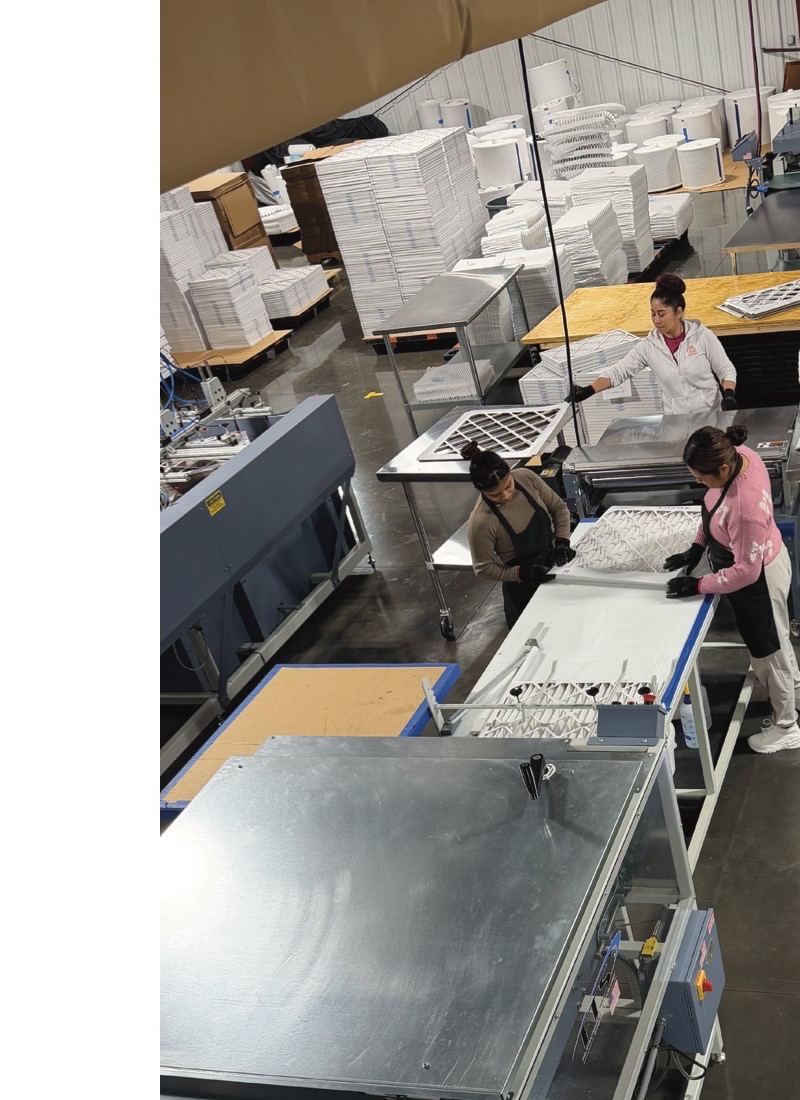 Workers assembling filters on the production floor
